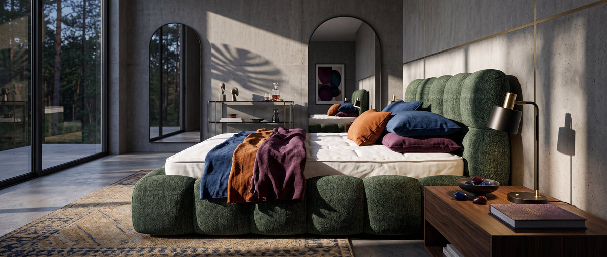 Modern bedroom with a green Mevy upholstered bed, colourful bedding, large mirrors and panoramic windows