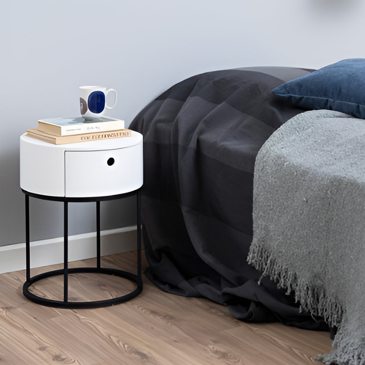 Ronda Round Bedside Table with a Drawer, Minimalist Style – in a room setting