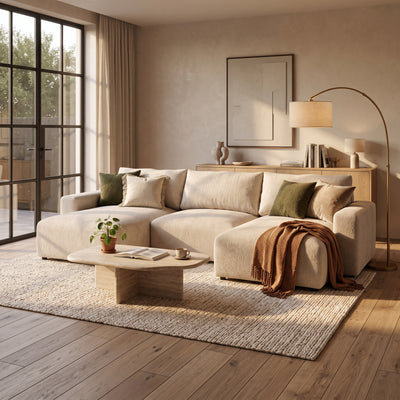 Canapé d'angle U Iskeli Taupe Crème (ARAGON 03) dans un salon lumineux avec une table en pierre, une lampe et un plaid – canapé d'angle pour le salon